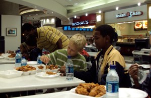Jack teaching Yemane how to use a fork